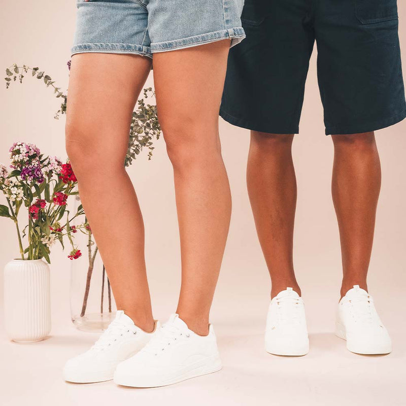 White vegan low top sneakers crafted from sustainable materials wearing short pants | NAE Vegan Shoes